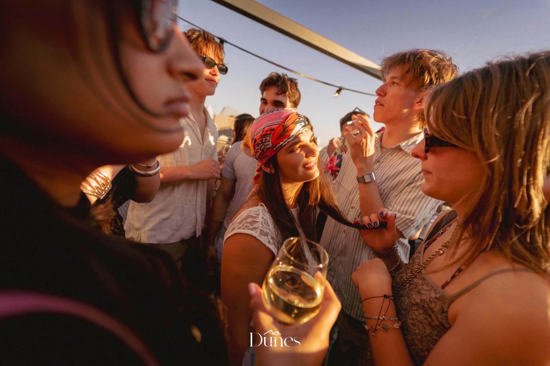 Guests at golden hour during a Dunes rooftop event