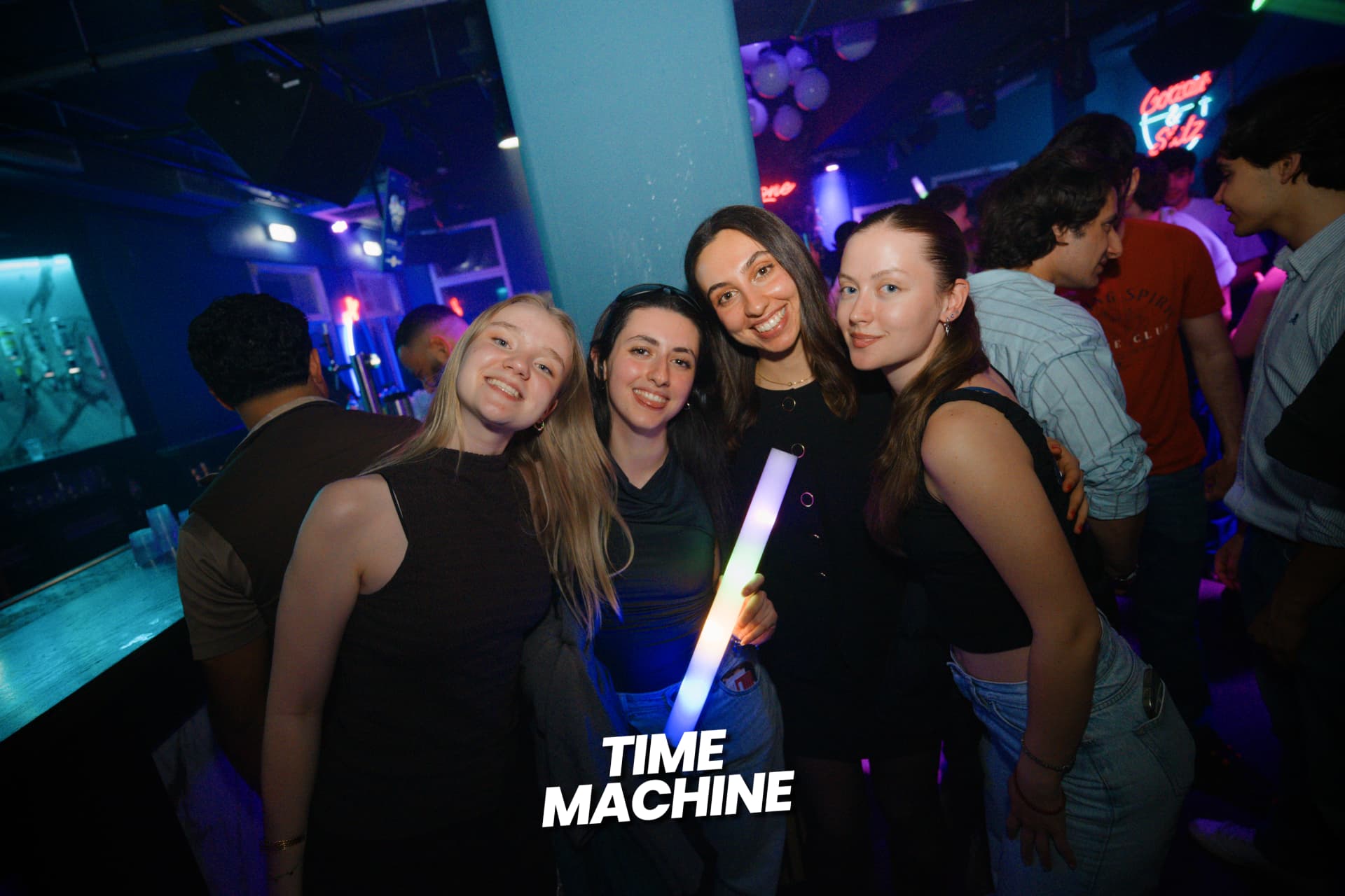 Friends smiling together at a Time Machine night