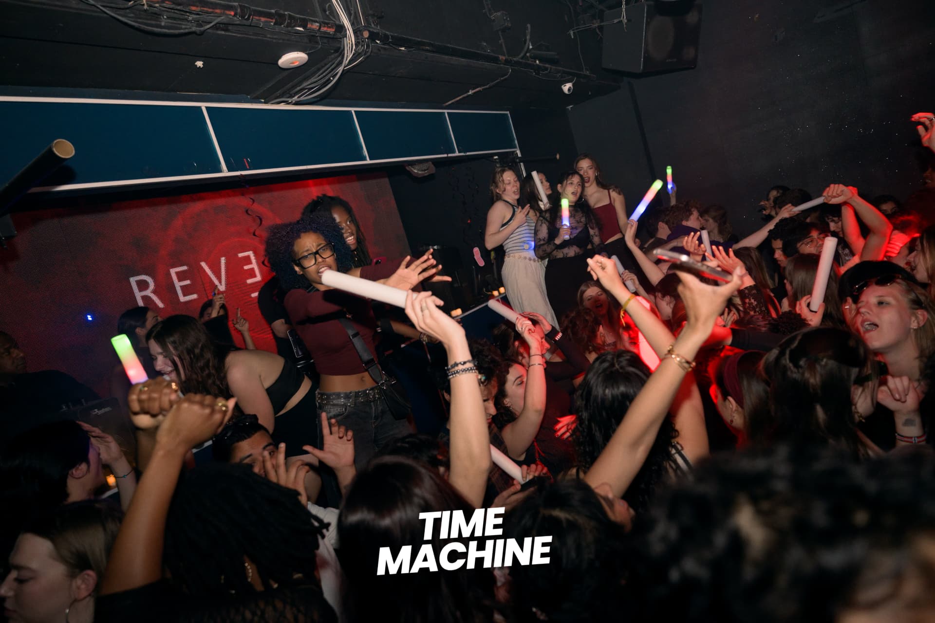 Crowd with glow sticks at a Time Machine night