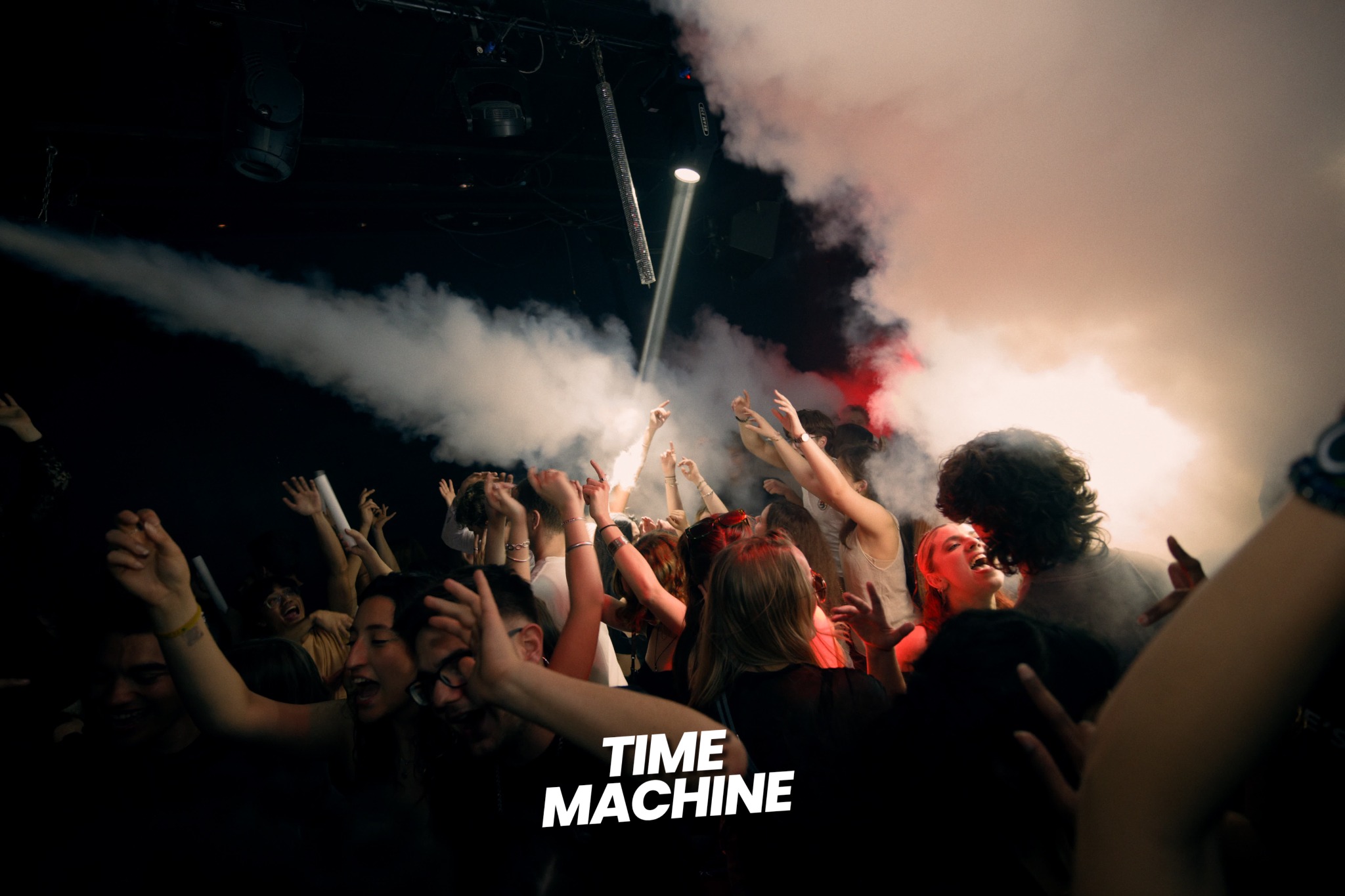 Time Machine crowd celebrating beneath smoke jets